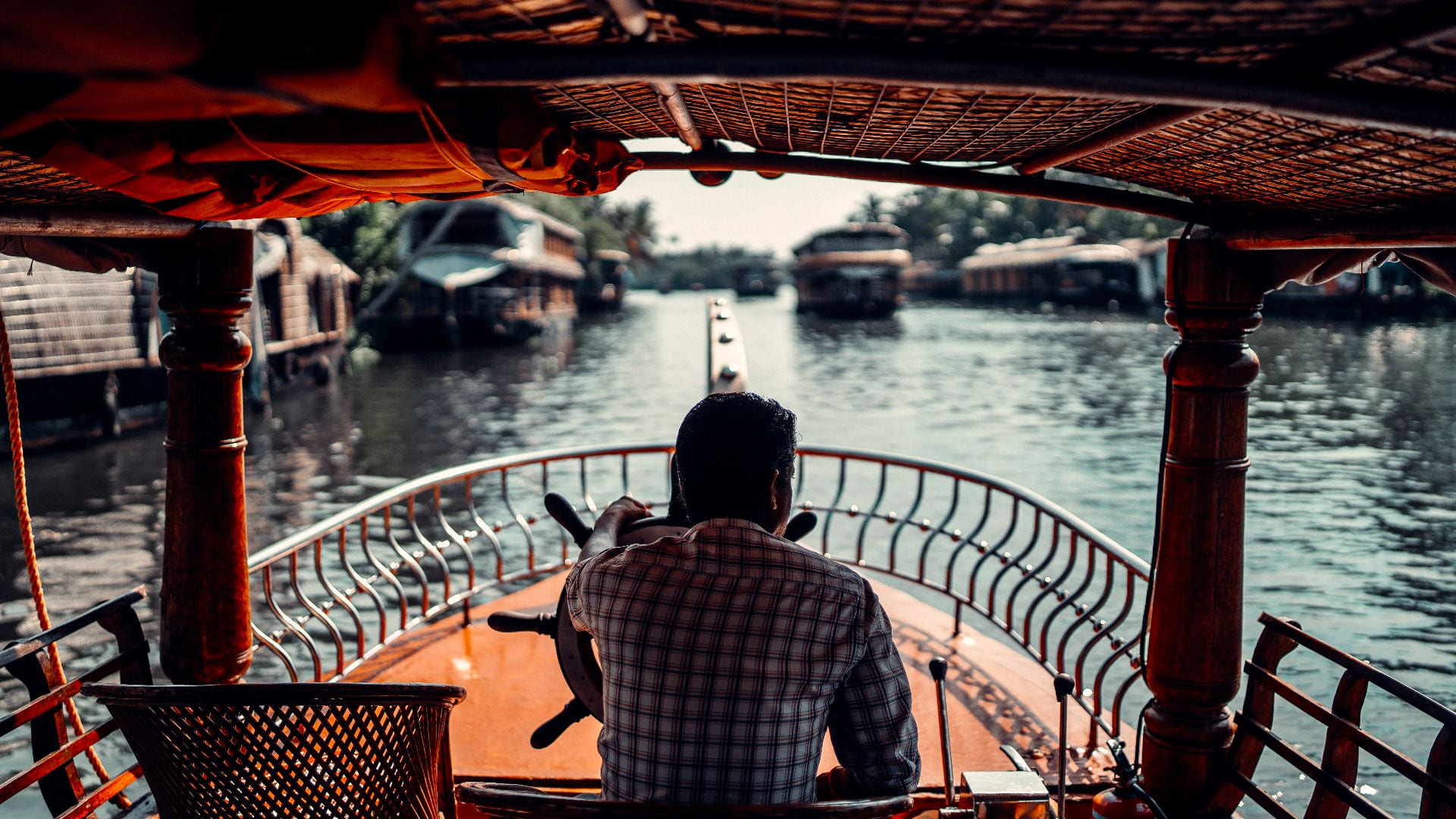 Man driving a boat in Kerala, India